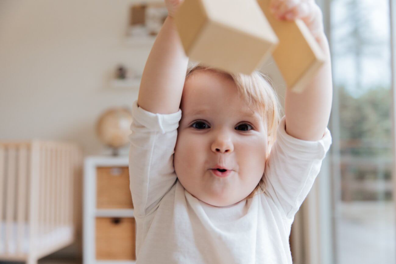 bebé jugando con bloques de madera en su habitación